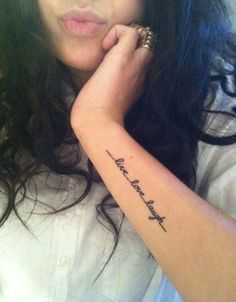 a woman with a small tattoo on her arm