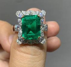 **Description Experience luxury with our exquisite **5 CT Colombian Lab-Grown Emerald ring set in lustrous 18K Gold**. This handcrafted jewel boasts a radiant octagon-shaped emerald, complemented by the sparkle of Roaya Diamond Moissanite. **Key Details - **Main Gemstone   - **Type Premium Octagon Lab-Grown Emerald   - **Size 9 x 12 mm    - **Metal   - **Type 18K Gold   - **Weight 7gm    - **Accent Stones   - **Round Brilliant Roaya Diamond Moissanite 3.5mm (2 pieces)   - **Oval Roaya Diamond Moissanite 3 x 4mm (4 pieces)   - **Marquise Roaya Diamond Moissanite 2 x 4mm (10 pieces) Indulge in the perfect blend of craftsmanship and elegance with this timeless piece. Luxury Octagon Diamond Jewelry, Green Diamond Cut Diamond Ring, Dazzling Green Diamond Ring For Formal Occasions, Luxury Green Emerald Ring With Diamond Cut, Green Diamond Ring For Formal Occasions, Elegant Green Octagon Diamond Ring, Luxury Green Asscher Cut Diamond Ring, Luxury Green Diamond Ring With Vvs Clarity, Elegant Octagon Gia Certified Emerald Ring