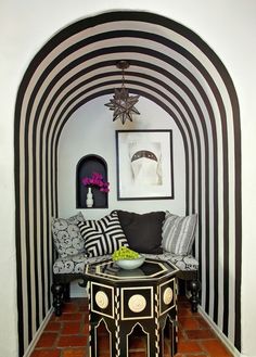 a living room with black and white striped walls