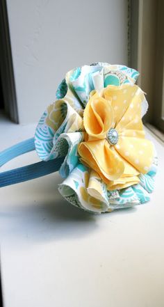 a close up of a flower on a headband with a window in the background