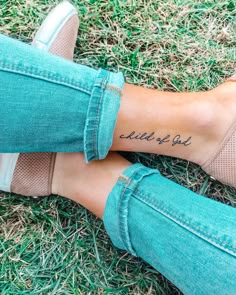 a woman's foot with the word love written on her left side and an arrow tattoo