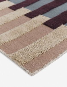 an area rug with different colors and patterns on it, including brown, blue, pink, grey and white stripes