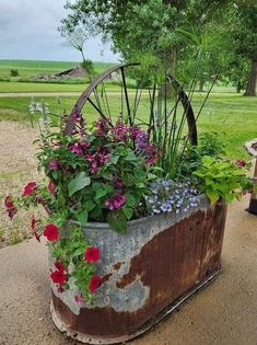 an old wagon is filled with flowers and plants