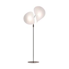 the floor lamp has two white glass shades on it's top and one is black