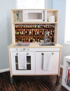 a toy kitchen with lots of jars on the shelves