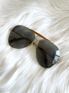 Super cute vintage aviator sunglasses with a thin gold frame, brown detail with metal circle on bridge and brown tinted lenses giving them the perfect retro vibe! Has some small scratches on lenses from storage. Label: --  Decade: 1970s/1980s Condition: Very good, glasses are deadstock and still in packaging but have some small scratches from storage Materials: Metal Measurements: 5 inches across 2.25 inches long 5 inch arms Be sure to check out of full collection of new (not vintage) sunglasses at totalrecallvintage.com! Vintage Aviator Sunglasses, Gold Aviator Sunglasses, Metal Circle, Vintage Sunglasses, Retro Vibe, Sunglasses Vintage, Aviator Sunglasses, Eyewear Sunglasses, Gold Frame