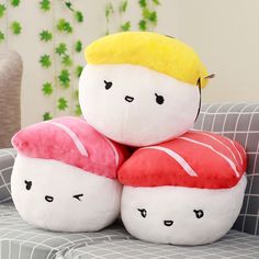 three stuffed toys are stacked on top of each other in the shape of sushi