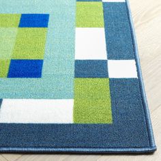 a blue and green rug on the floor