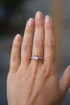 a woman's hand with a diamond ring on it