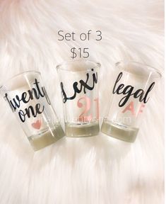 three shot glasses with the words twenty, one legal and two are on top of a white fur surface