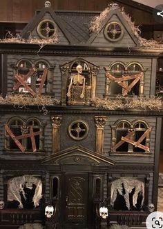 a black doll house with lots of decorations on it