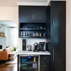 a kitchen with black cabinets and white counter tops