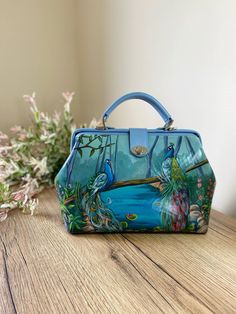 Hand-painted leather doctor handbag Material: genuine leather, metal hardware, soft tissue lining, high-quality acrylic paint Sizing: height - 9,5" (24cm), length - 12" (30cm), the width - 6" (15cm) Personalization: yes Features of this bag: - Hand-painted with a special blend of durable and waterproof acrylic paints. It is also covered with lacquer to be protected from scratches. - Made of genuine leather + metal hardware; and an adjustable strap (optional) - Two inner pockets: a zipped pocket Painted Handbag, Handbag Luxury, Luxury Crossbody, Doctor Bag, Hand Painted Leather, Gift For Woman, Crossbody Bag Women, Handmade Bag, Bag Handmade