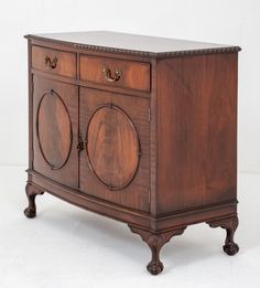 an antique wooden cabinet with two doors