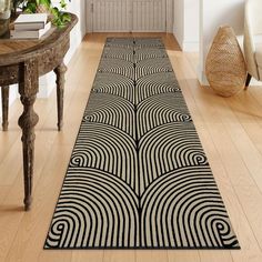 a black and white area rug on a wooden floor