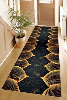 a hallway with a black and gold rug on the floor next to a potted plant