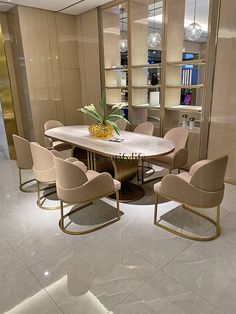 a dining room table with chairs and a vase filled with pineapples on it