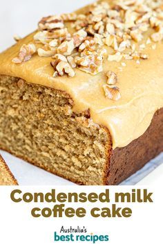 a close up of a loaf of cake with frosting on top and nuts in the middle