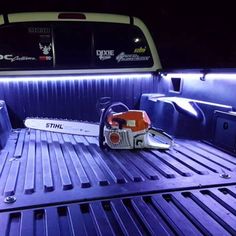 there is a chainsaw in the back of a truck with its lights turned on