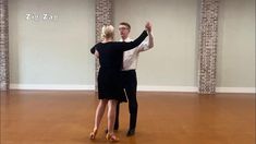 a man and woman dancing in an empty room