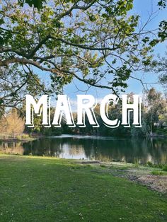 the words march are overlaided with trees and grass near a lake in front of a blue sky