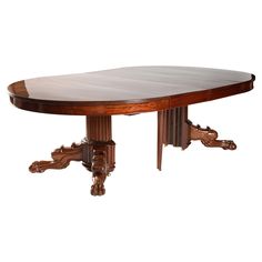 an oval dining table with two leaves on each end