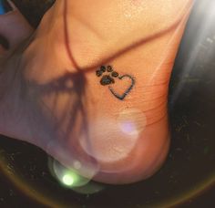 a dog paw with a heart tattoo on it