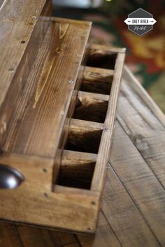 a wooden box with drawers on top of a table