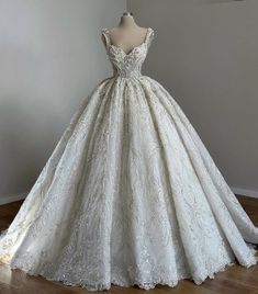 a white wedding dress on display in a room