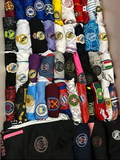 many different colored socks are stacked on top of each other