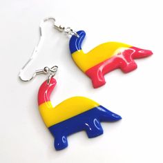 Unleash your unique style with these pansexual Dino Drop Earrings. Featuring the pansexual expression of embracing diversity. Perfect for adding a touch of quirkiness to any outfit! All orders are packaged with care. Each box includes tissue paper, a tealight and a KelZo postcard. Product details: Polymer clay Approx 3.5cm Hypoallergenic stainless steel hooks ****Colours may vary slightly from image due to resolution differences. Colour patterns may not match photographed item but will be cut fr Embracing Diversity, Pansexual Flag, Flag Design, Tealight, Tissue Paper, Color Patterns, Tea Lights, Unique Style, Polymer Clay