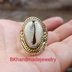 Cowrie Ring, Cowrie Shell Ring, Beach Shell Ring, Beach Cowrie Ring,Indian style Cowrie shell silver tone ring Handmade item Gemstone :-  Cowrie shell Merarial :- Brass, 925 Sterling Silver, Gold plated ,Rose Gold plated\ Style:- Boho & hippie This ring will definitely become one of your favorite piece-the ring makes a statement of its own. The ring was manufactured in India and part of a limited edition collection. For More Products Visit Mt Silver Shell Rings For Beach, Ocean-inspired Shell Rings For Beach, Silver Shell-shaped Rings For Beach, Silver Shell With Ocean-inspired Style For Vacation, Silver Ocean-inspired Shell For Vacation, White Shell-shaped Rings For Beach, White Beach Ring Jewelry, Handmade Oval Jewelry For Beach, Bohemian Oval Jewelry For The Beach