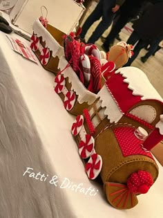 a close up of a decorated shoe on a table with people in the back ground