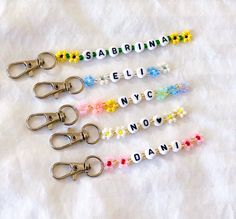 four pairs of scissors with name beads on them