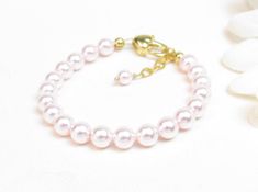 "Pink Pearl Bracelet with 14K Gold-Filled Clasp for Infant, Baby or Little Girl: This timeless style is created with 5mm rosaline Swarovski crystal pearls and a 14K gold-filled oval lobster clasp with a 1/2\" \"Grow with Me\" extender chain. All metal components are 14K gold-filled. Note: The heart-shaped lobster clasp has been discontinued. This item now has a standard gold-filled oval lobster clasp. Arrives packaged in my signature high-quality canvas gift bag. Beautiful and ready for gift giv Pink Pearl Beaded Bracelet For Birthday, Pink Pearl Bracelet For Birthday, Hypoallergenic Pearl Bracelet For Birthday, Elegant Pink Pearl Bracelet For Birthday, Canvas Gift Bag, Pink Pearl Bracelet, Baby Bracelet, Confirmation Gifts, Gold Baby