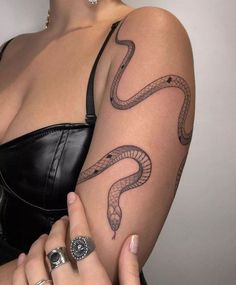 a woman with a snake tattoo on her arm