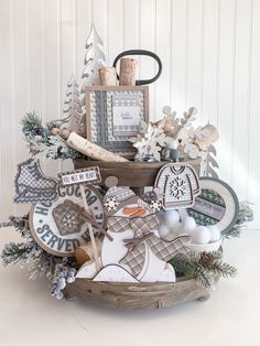 a basket filled with lots of different types of christmas items and decorations on top of a table