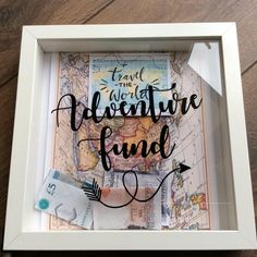 the words adventure fund are displayed in a white frame on a wooden table with an arrow