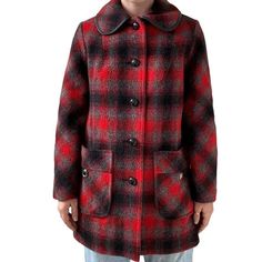 The unique checkered wool fabric in red and black is a statement piece that will make you stand out in any crowd. Made in the 1970s, this jacket is a perfect addition to your vintage clothing collection. The mid-mod style and lumberjack design add a touch of ruggedness to your outfit, making it perfect for any occasion. The jacket is available in size M.  Size M Color: red & black  Material: wool blend  Closure: button  Collar to hem: 34"  Pit to pit: 21"  Sleeve: 26"  Modeled on a medium/size 6/ 5 foot 7/ 140lbs/ 34 C/ 28" inch waist Black Retro Wool Outerwear, Retro Black Wool Outerwear, Retro Plaid Outerwear With Button Closure, Vintage Houndstooth Outerwear For Winter, Retro Single Breasted Plaid Outerwear, Vintage Houndstooth Outerwear, Red Vintage Wool Outerwear, Vintage Plaid Outerwear With Button Closure, Retro Red Wool Outerwear