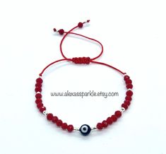 The post is for one individual bracelet. This beautifully handmade bracelet is made of 4mm red rondelle crystal beads, small silver colored beads, with a turkish glass eye bead that is 6mm. They are made with red nylon string and are adjustable to fit most wrists as it has a sliding knot to adjust. These are a great accessory for everyday wear. This bracelet is great for spiritual and evil eye purposes. It is believed that when a person wears or carries an evil eye with them, it guards against m Red And Silver, Protection Bracelet, Sliding Knot, Glass Eyes, Handmade Bracelet, Organza Bags, Chicago Il, Eye Color, Handmade Bracelets