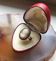 Item: Vintage 1940s Camexco Italy Carved Shell Cameo 14K Gold and 800 Silver Ladies Ring. The silver portion of the ring is stamped Camexco. The interior of the band is stamped 14K. The ring box shown in the photos is not included in the purchase of the ring. Measurements: Size 5.5. It weighs 5.21 grams. Condition: Good, previously owned. There are minor signs of age/use. Most notable is the flaw inside the band where it meets the cameo, it is visible in the photos. The top edge (11 o'clock) of Antique Oval Engraved Ring For Collectors, Antique Oval Collectible Rings, Antique Cameo Ring Collectible, Antique Ring Jewelry For Vintage Events, Antique White Gold Engraved Ring Collectible, Antique White Gold Signet Ring Collectible, Vintage White Gold Engraved Ring, Vintage Oval Signet Ring, Vintage Ring Jewelry For Vintage Events