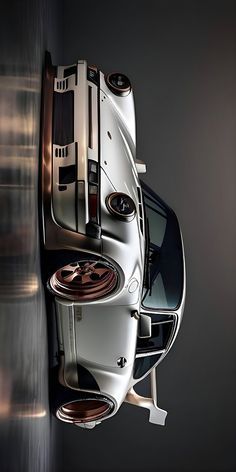 an overhead view of a car with its hood up and the top down, on a dark background