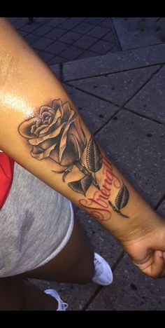 a woman's arm with a rose tattoo on it and the words happy birthday written in red ink