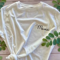 Share your greatest achievement with an everyday white tee dedicated to being a mama. This white T is the perfect shirt for running errands, hanging with your little ones, or celebrating being a mom with your mom squad. T-shirts are unisex sizing. Recommended washing instructions: Wash and dry garments inside out Wash with cold or warm water Use a mild detergent Tumble dry low or hang dry Do not iron directly on the design White Letter Print T-shirt As Gift, White Relaxed Fit T-shirt For Family Matching, Simple White T-shirt With Text Print, White T-shirt For Mother's Day Gift, Relaxed Fit T-shirt With Name Print For Mother's Day, Mother's Day Letter Print T-shirt, Mother's Day Graphic Tee T-shirt, Mother's Day Graphic Tee With Name Print, White Letter Print T-shirt As A Gift