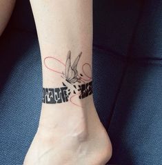 a woman's foot with a tattoo on her left ankle and the word love is written across it