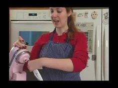 a woman in an apron is holding a pink fire hydrant