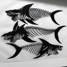 some fish that are on the side of a sheet of paper with black and white ink