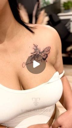 a woman with a bee tattoo on her chest holding a piece of paper in her hand