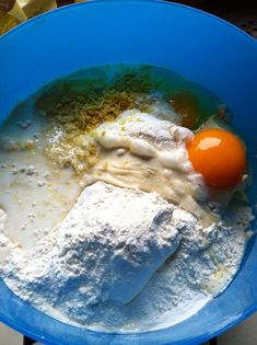 an egg and flour in a blue bowl