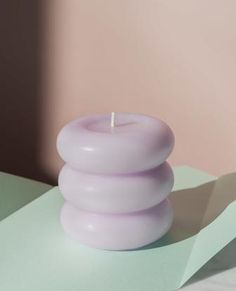 a purple candle sitting on top of a table